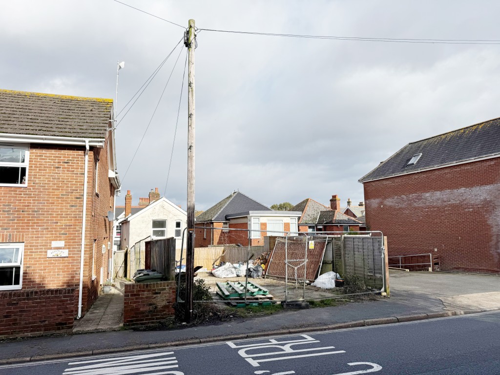 Lot: 27 - VILLAGE CENTRE LAND WITH POTENTIAL - View of entrance with temporary fencing